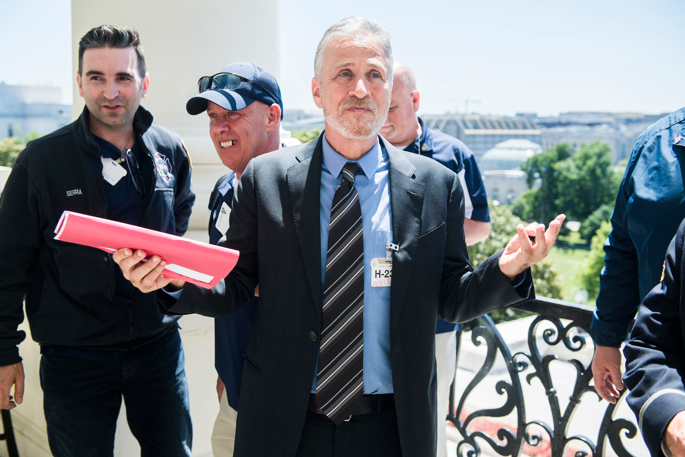 Comedian and advocate Jon Stewart along with 9/11 responders are seen on the Speaker’s balcony after a meeting in the Capitol with Speaker Nancy Pelosi about funding for the September 11th Victim Compensation Fund. (Tom Williams/CQ Roll Call)