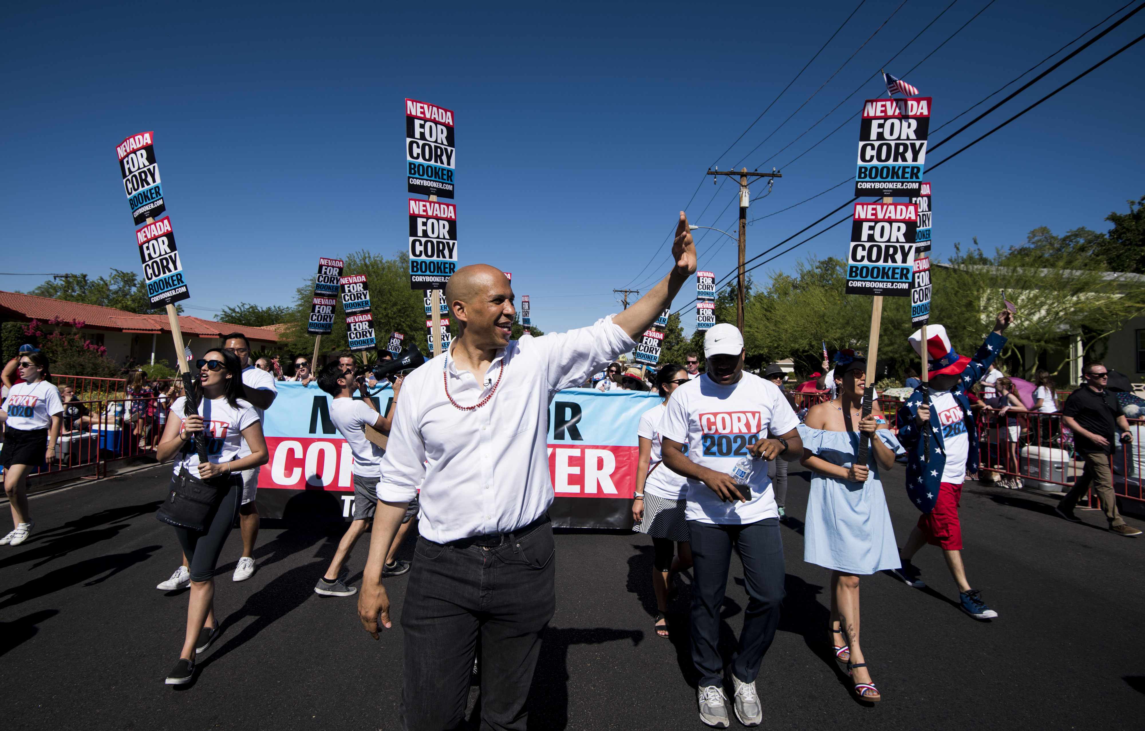 Presidential candidate Cory Booker waves as he marches in the Boulder City Damboree Celebration in Nevada on July 4. Many of those who meet him are invariably won over, Murphy writes, but with 24 candidates in the race, how do you scale that kind of in-person connection? (Bill Clark/CQ Roll Call)