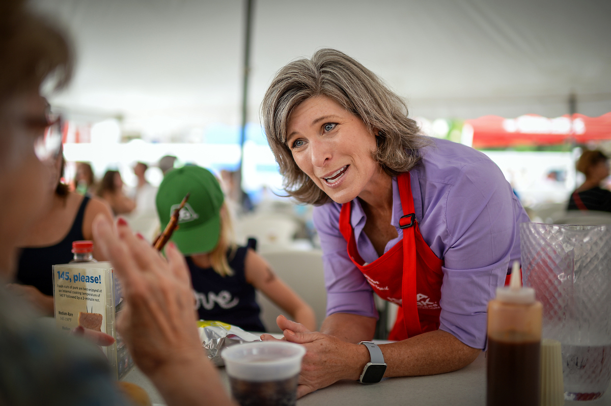 Iowa Sen. Joni Ernst talks with fairgoers at the Iowa Pork Producers Association tent at the state fair in Des Moines earlier this month. (Caroline Brehman/CQ Roll Call file photo)