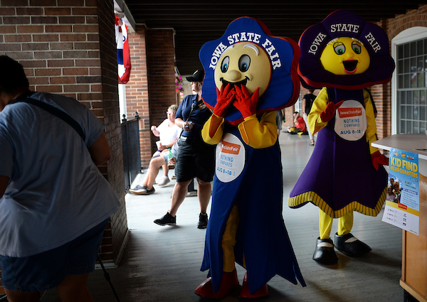 Iowa State Fair mascots walk by the Administration Building at the Iowa State Fair on Monday. (Caroline Brehman/CQ Roll Call)