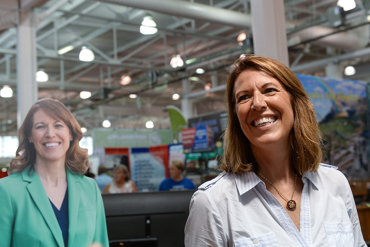 Rep. Cindy Axne, D-Iowa, talks with fairgoers at the Iowa Democratic Party booth. (Caroline Brehman/CQ Roll Call)