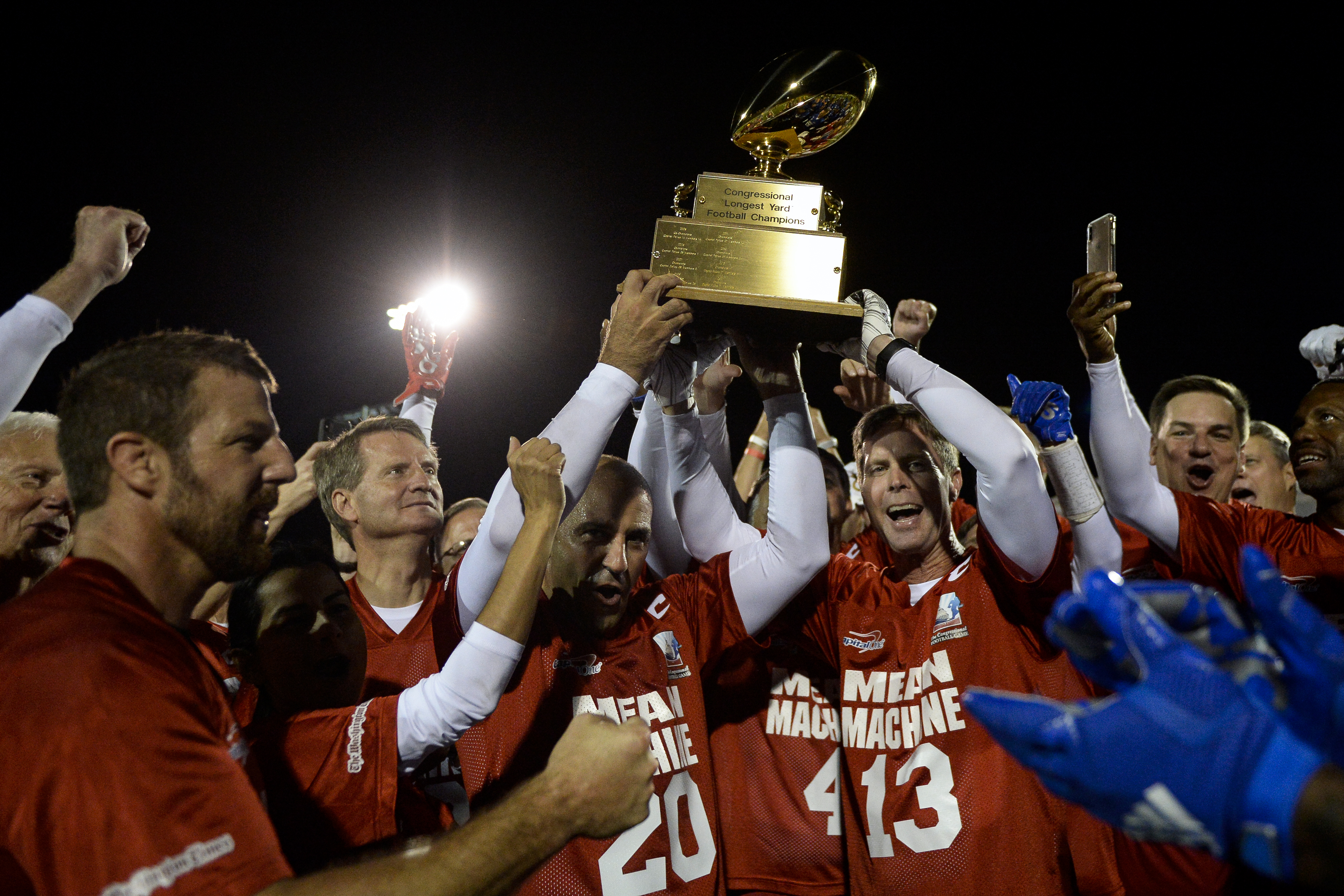 UNITED STATES - SEPTEMBER 24: The Mean Machine team, consisting of members of Congress, hold up the winning trophy after defeating the Guards team, made up of current and former U.S. Capitol Police members, during the annual Congressional Football Game for Charity on Tuesday, Sept. 24, 2019. (Photo by Caroline Brehman/CQ Roll Call)