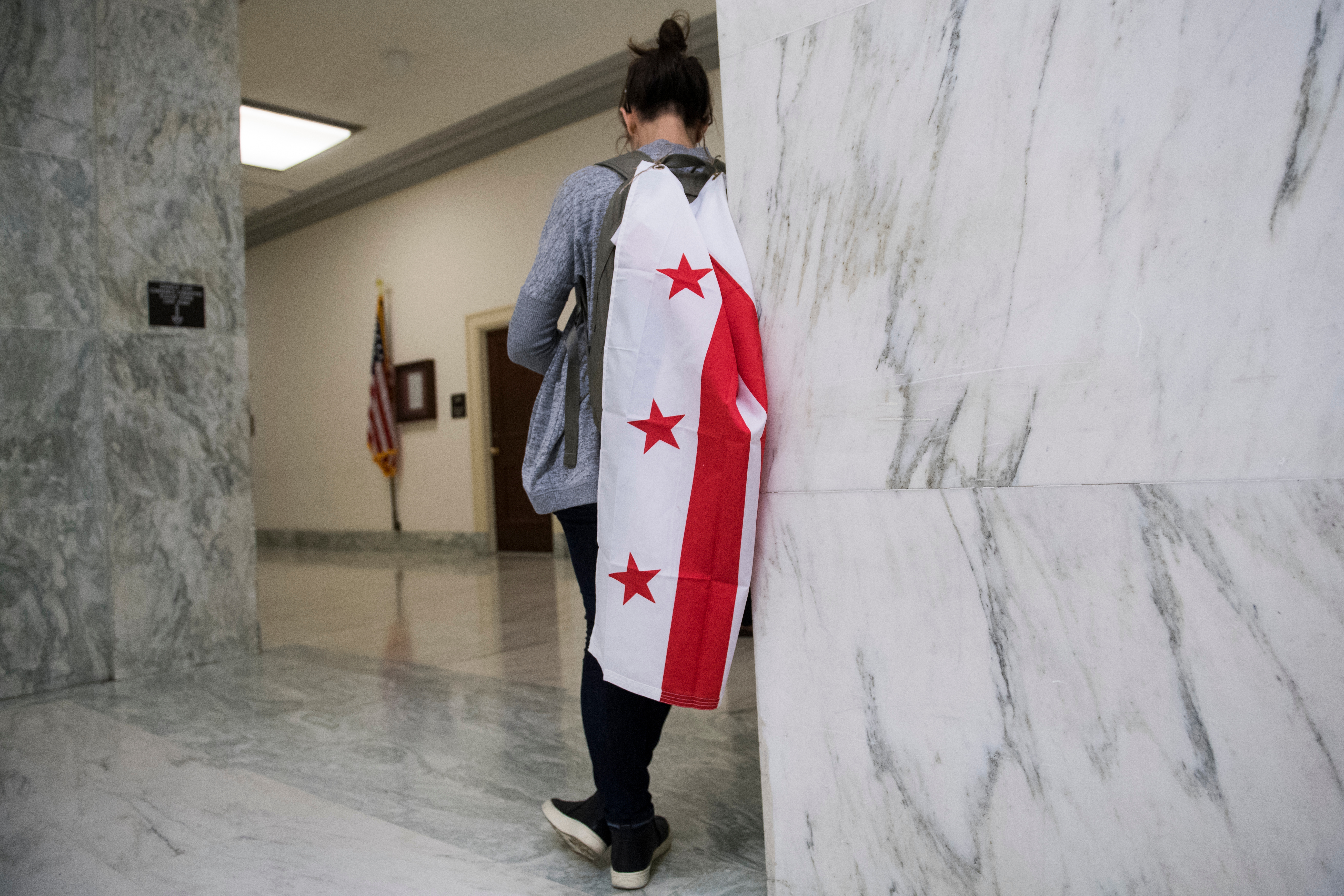 UNITED STATES - SEPTEMBER 19: A supporter of D.C. statehood waits outside the House Oversight and Reform Committee hearing titled “H.R. 51: Making D.C. the 51st State,” in Rayburn Building on Thursday, September 19, 2019. (Photo By Tom Williams/CQ Roll Call)