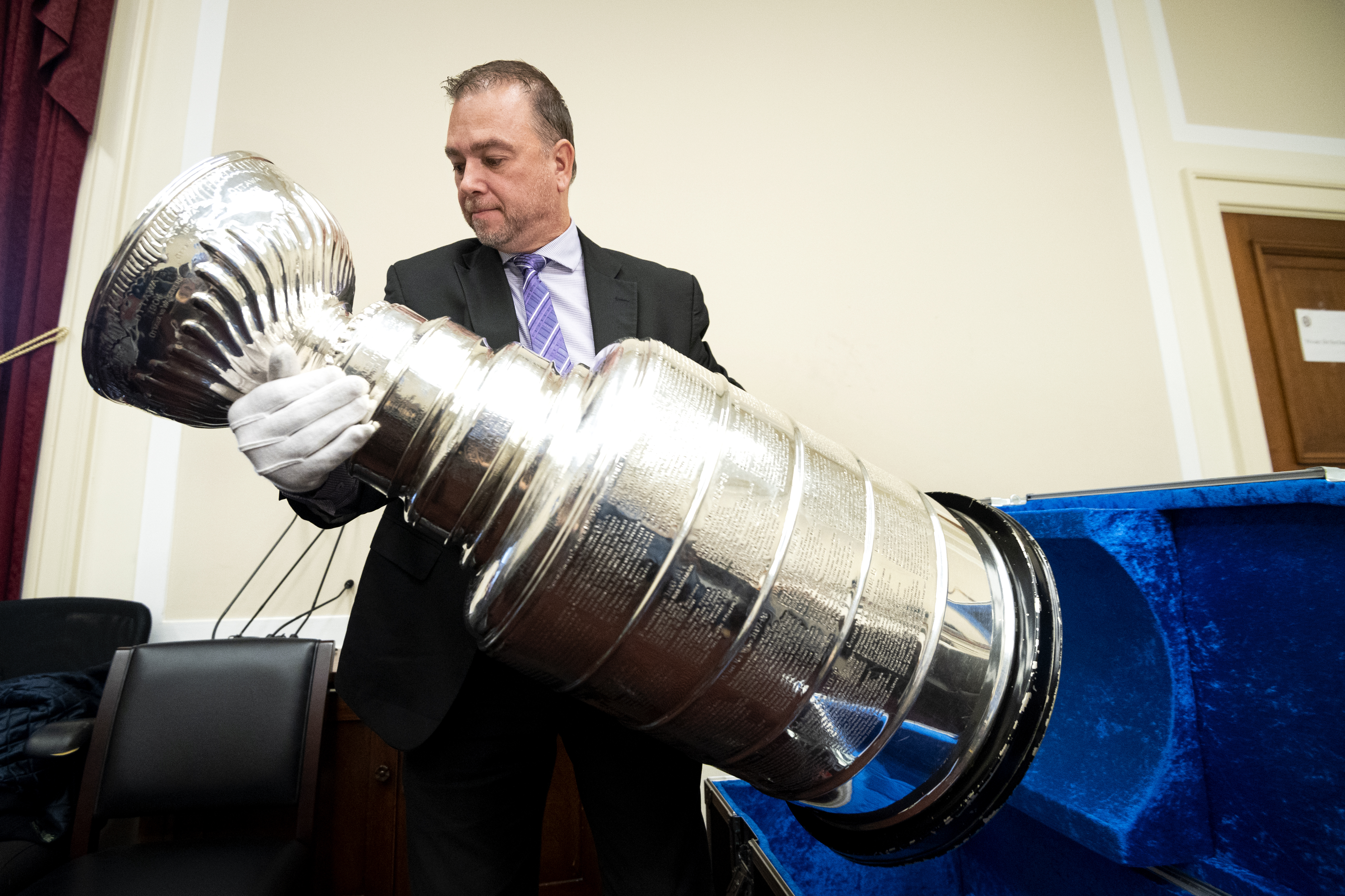 The Stanley Cup is taken out of its case before being put on display in the Rayburn Office Building on Wednesday. (Caroline Brehman/CQ Roll Call)