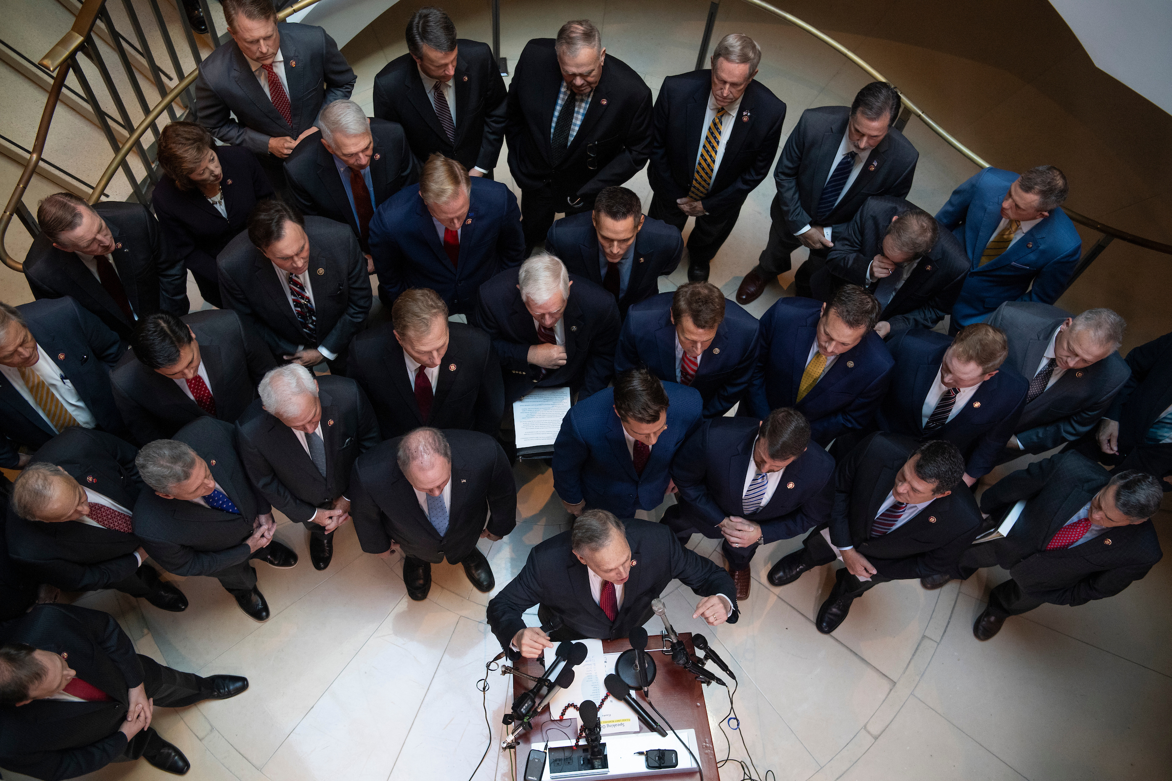 Rep. Andy Biggs, R-Ariz., at podium, speaks during a news conference outside the Laura Cooper, deputy assistant secretary of defense, deposition related to the House’s impeachment inquiry on Wednesday, October 23, 2019. The Republican members were calling for access to the deposition. (Tom Williams/CQ Roll Call)