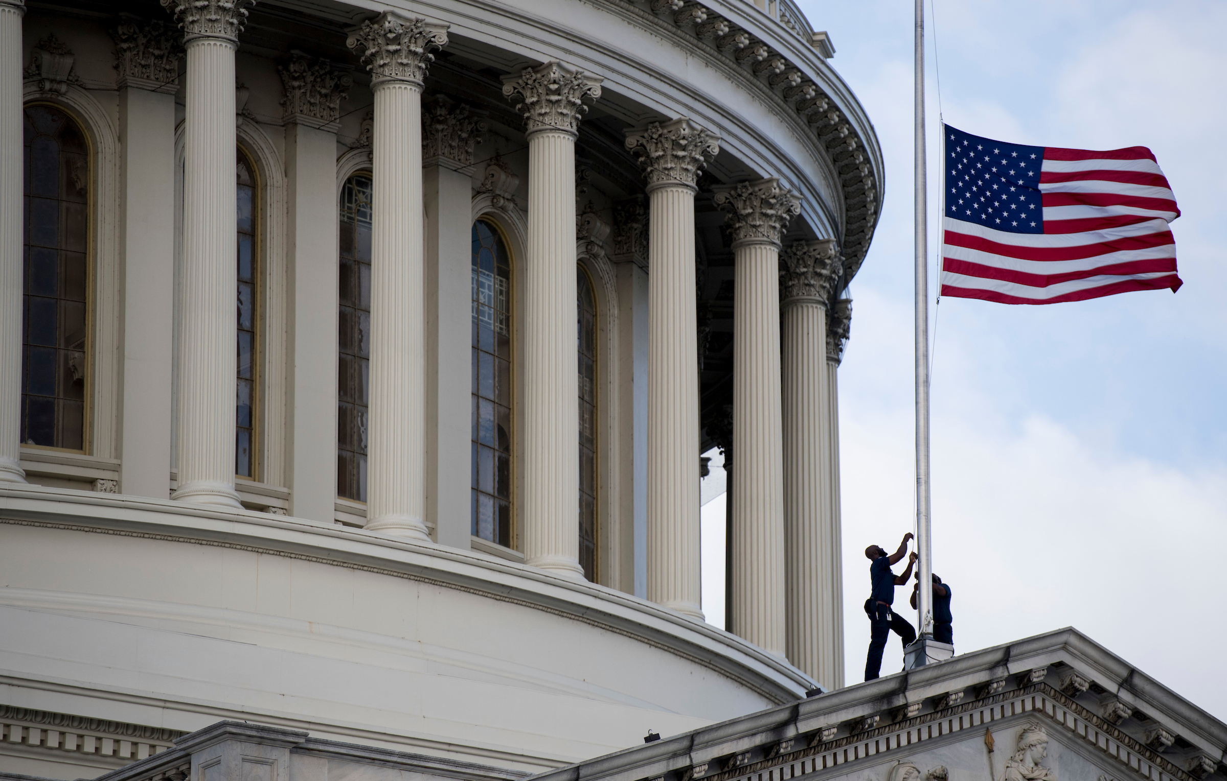 UNITED STATES - OCTOBER 17: Capitol workers lower the flag to half staff after the passing of Rep. Elijah Cummings, D-Md., on Thursday, Oct. 17, 2019. (Photo By Bill Clark/CQ Roll Call)