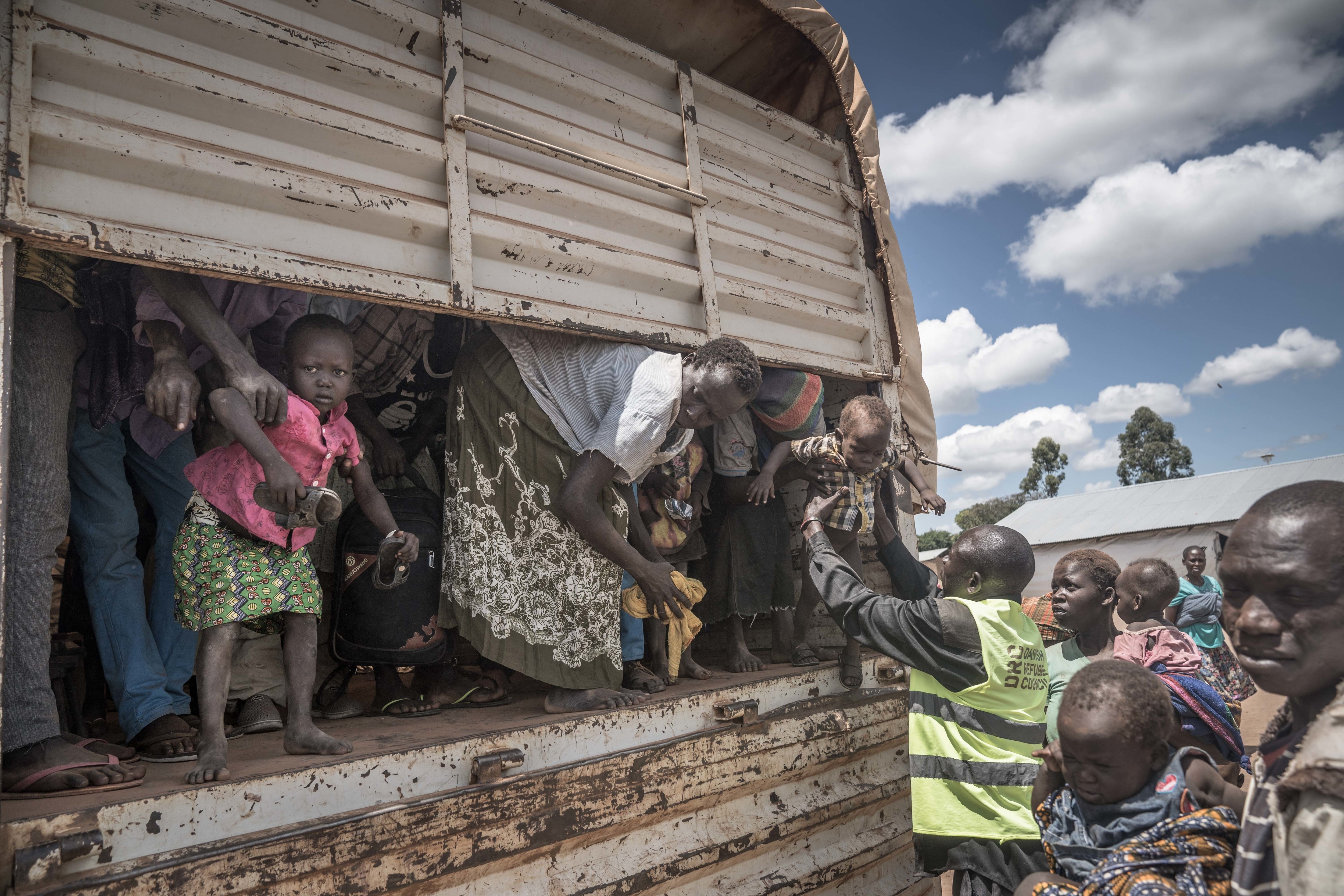 South Sudanese refugees are helped off a truck at the Kuluba refugee center in northern Uganda in May 2018. (Geovien So/SOPA Images/LightRocket via Getty Images file photo)