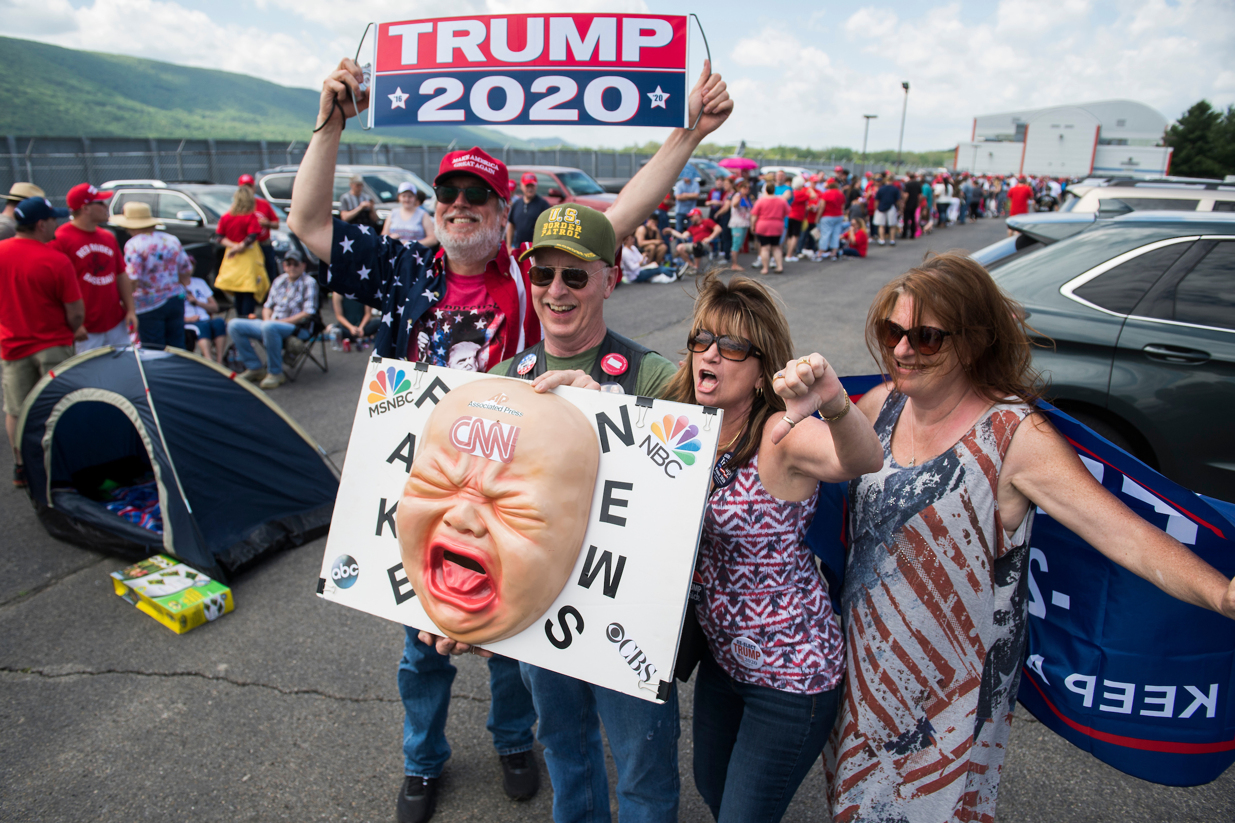 Supporters of President Donald Trump pose for a picture while waiting to enter his rally at the Williamsport Regional Airport in Montoursville, Pa., on May 20, 2019. (Tom Williams/CQ Roll Call file photo)