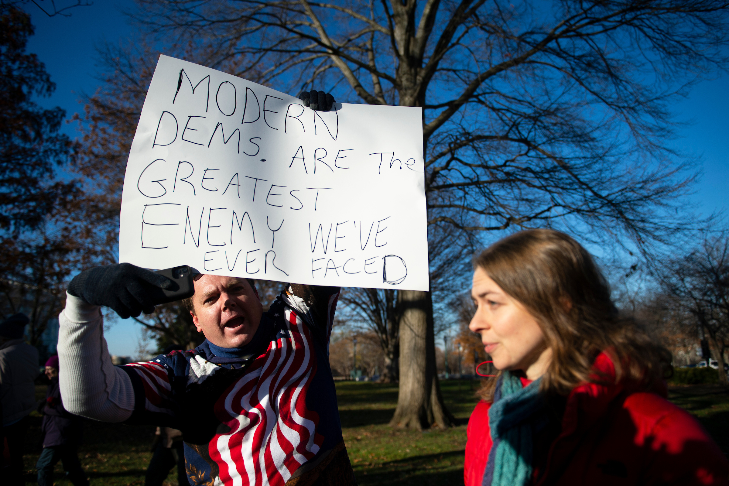 A Trump supporter yells at pro-impeachment demonstrators as they rally in front of the Capitol on Wednesday. (Caroline Brehman/CQ Roll Call)