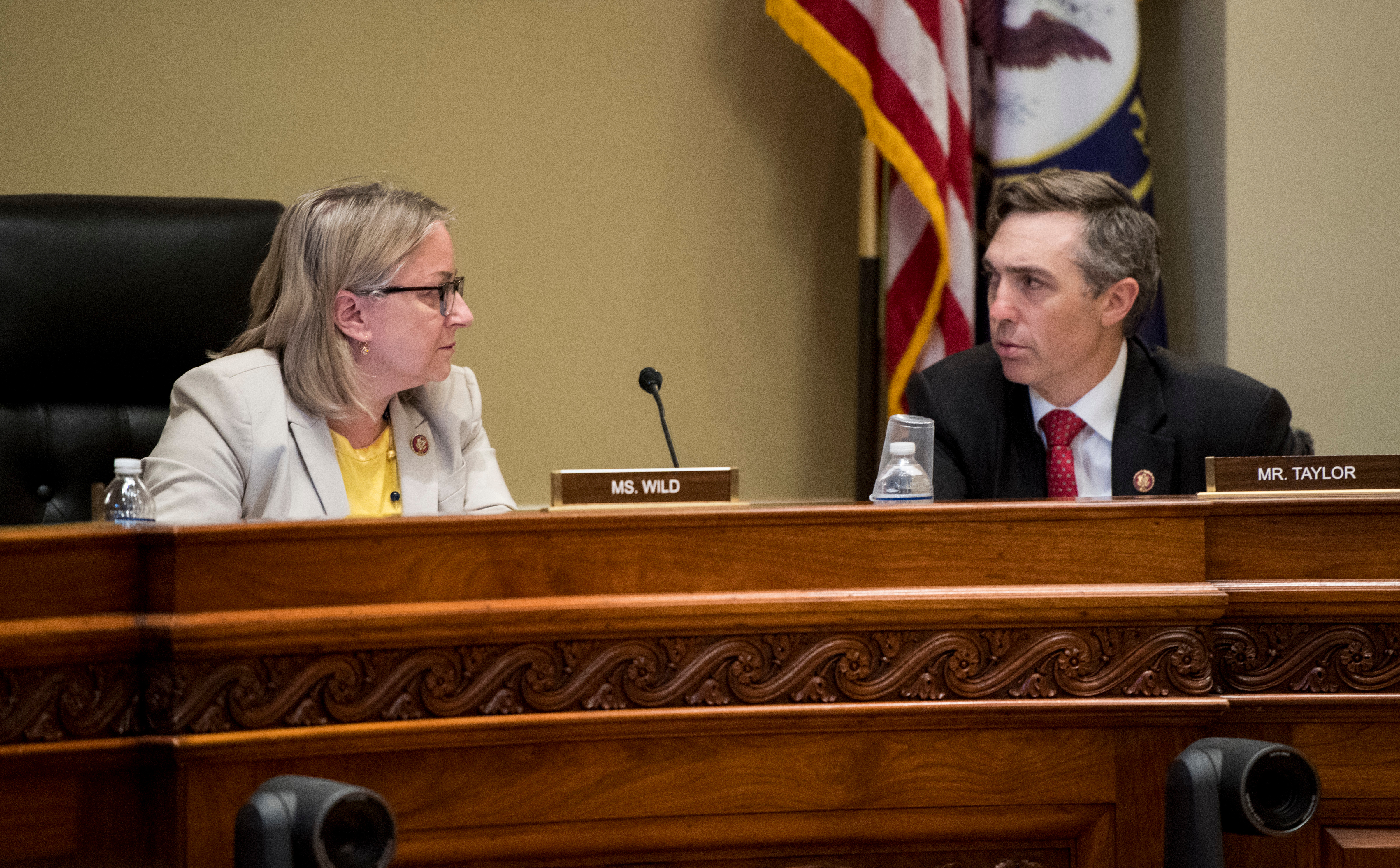 UNITED STATES - JULY 25: Rep. Susan Wild, D-Pa., left, and Rep. Van Taylor, R-Texas, talk before the start of the House Committee on Ethics’ Outside Positions Working Group discussion in the Longworth House Office Building on Thursday, July 25, 2019. The group is working to draft proposed regulations governing House Members, officers, and employees’ outside positions. (Photo By Bill Clark/CQ Roll Call)