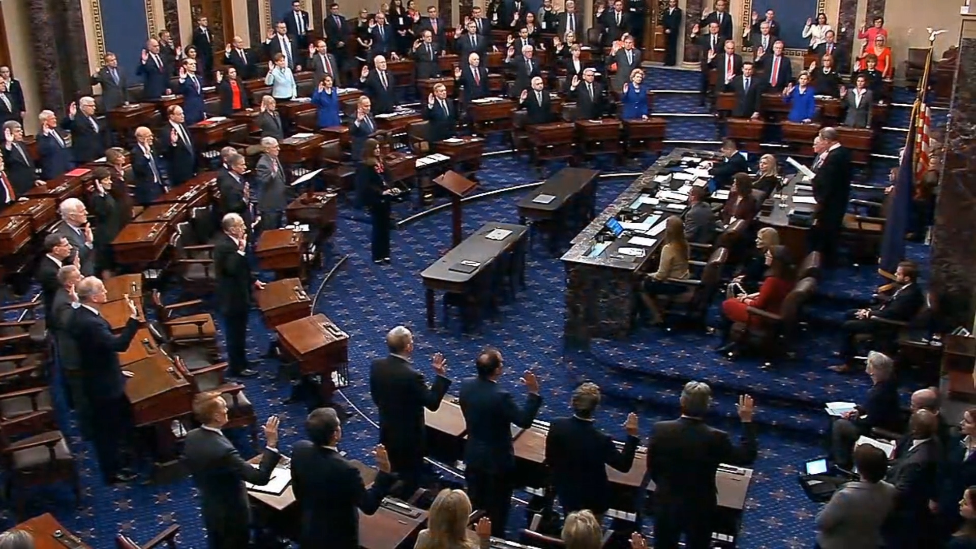 Senators raise their hands as Chief Justice John G. Roberts Jr. administers the oath of the Senate Court of Impeachment Thursday. (Screenshot/Senate Recording Studio)