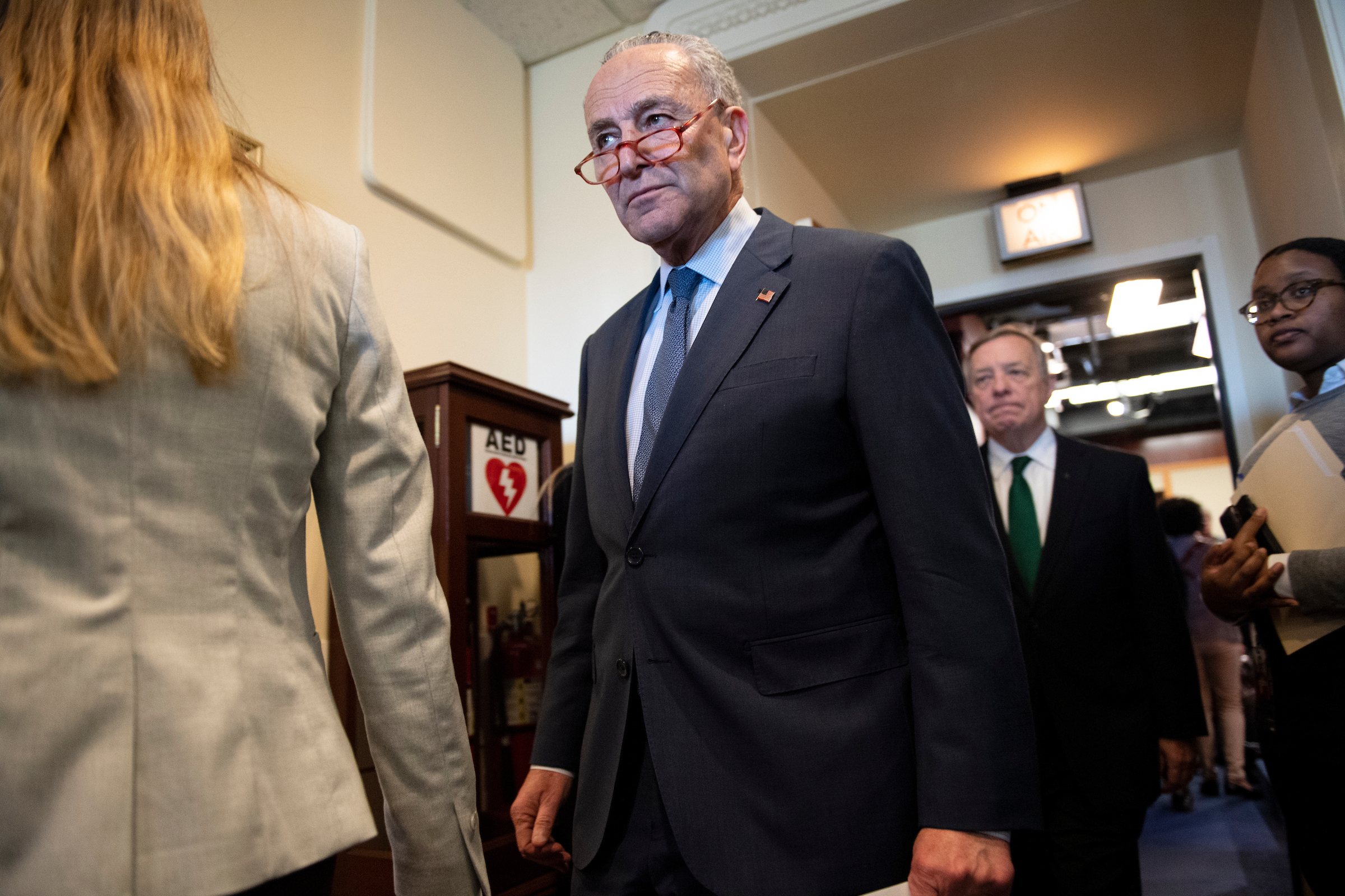 Senate Minority Leader Charles E. Schumer, followed by Democratic Sen. Richard J. Durbin, leaves a news conference Tuesday. The Senate rejected all of the amendments Schumer introduced to try to change the rules for President Donald Trump’s impeachment trial. (Caroline Brehman/CQ Roll Call)