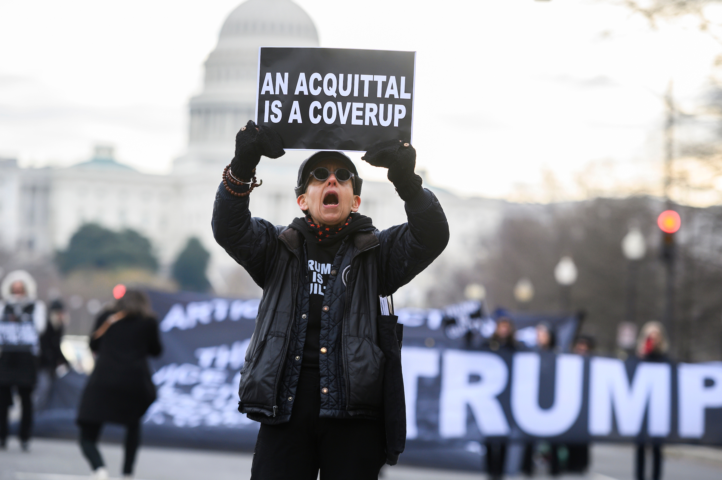 Laurie Arbeiter protests on Pennsylvania Avenue before the continuation of the impeachment trial of President Donald Trump on Friday. (Tom Williams/CQ Roll Call)