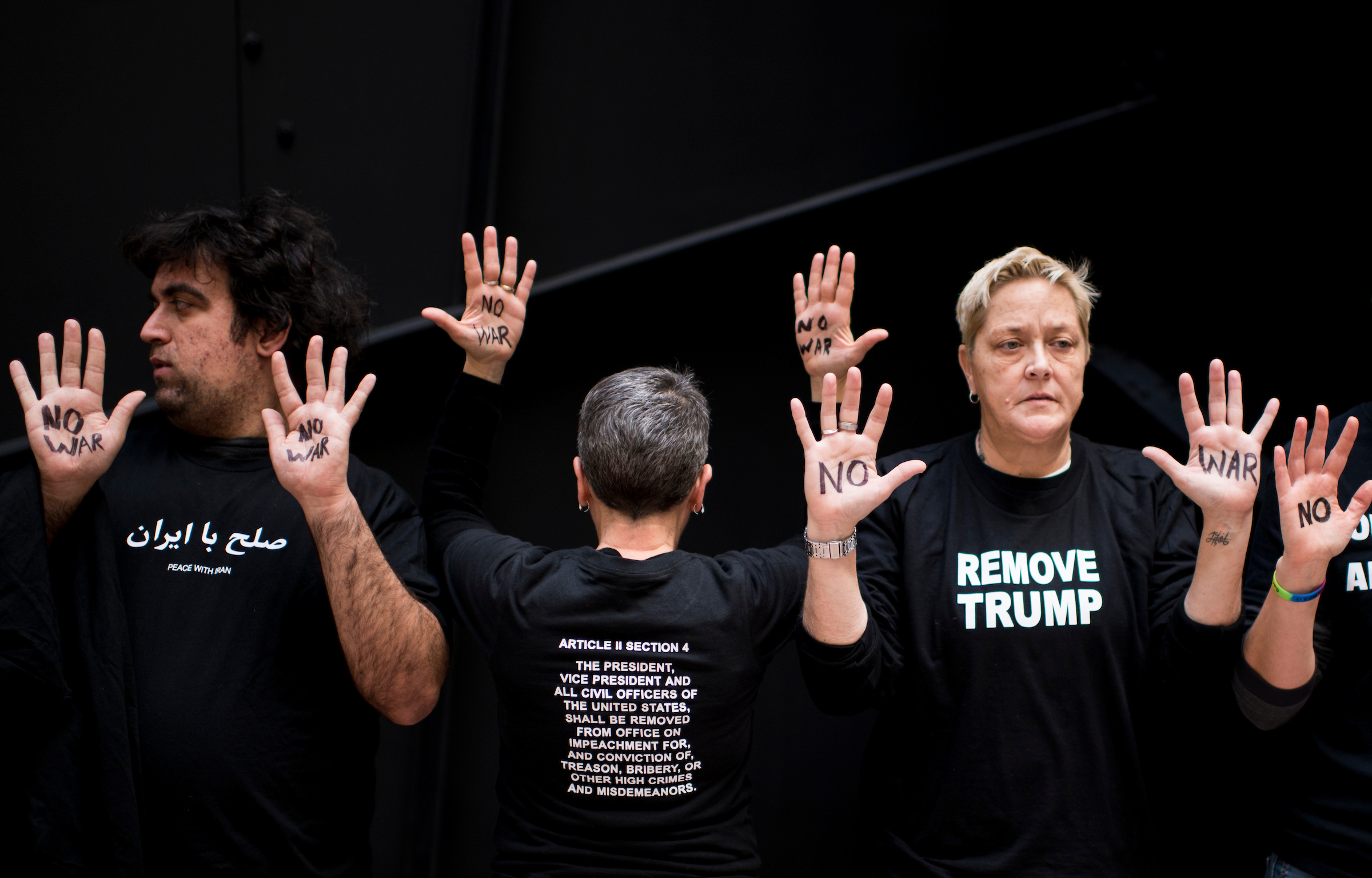 UNITED STATES - JANUARY 6: Two dozen protesters participate in the "Swarm the Senate" rally in the Hart Senate Office Building urging action to "impeach, remove, indict and jail" President Trump on Monday, Jan. 6, 2020. The protesters held up their hands with the words “no war.” (Photo By Bill Clark/CQ Roll Call)