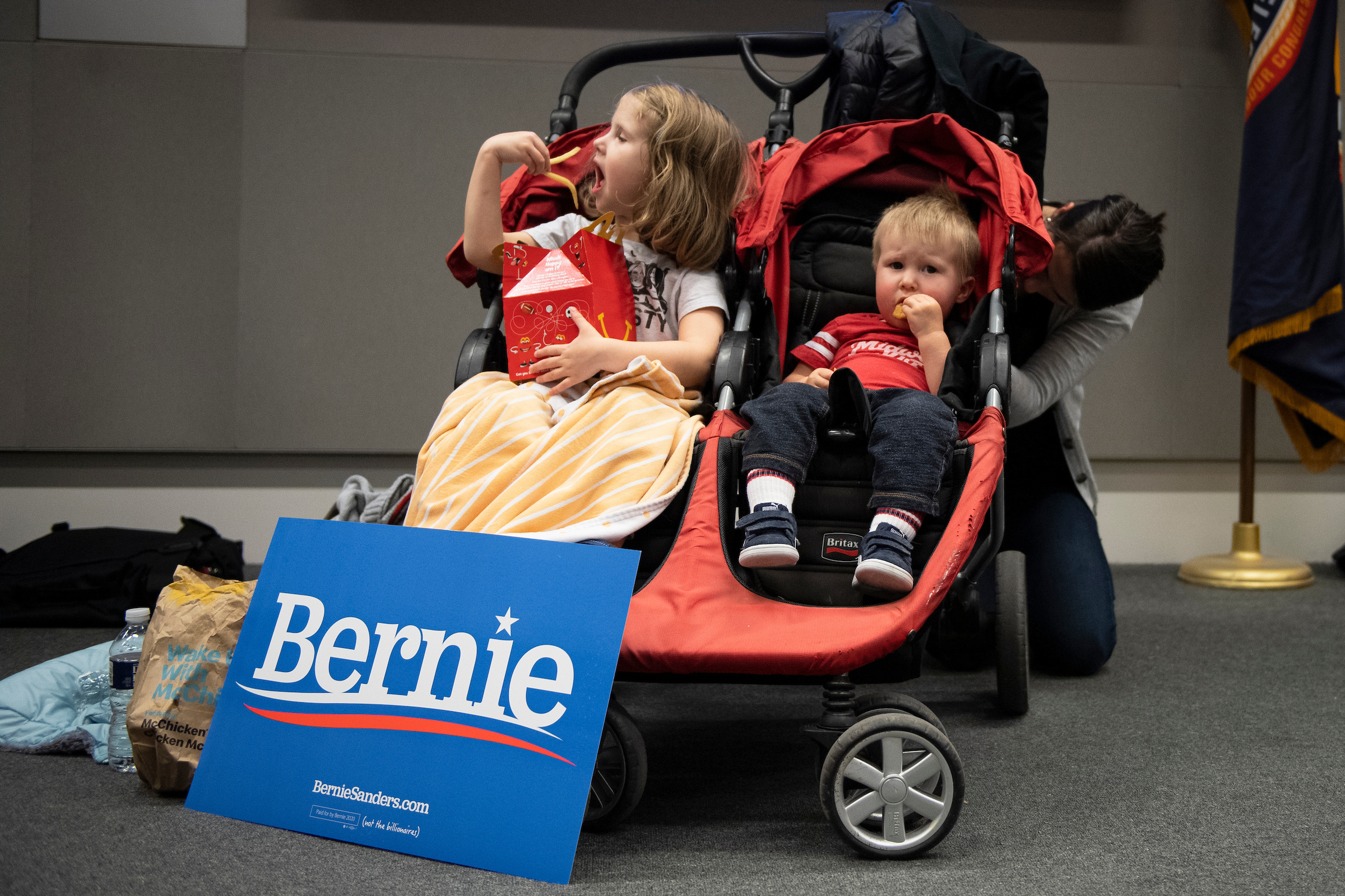 UNITED STATES - FEBRUARY 3: Aurelia Peterson, 3, left, and Jude Peterson, 1, eat food before the start of a Democratic satellite caucus at the International Brotherhood of Electrical Workers Hall on Monday, Feb. 3, 2020. (Photo by Caroline Brehman/CQ Roll Call)