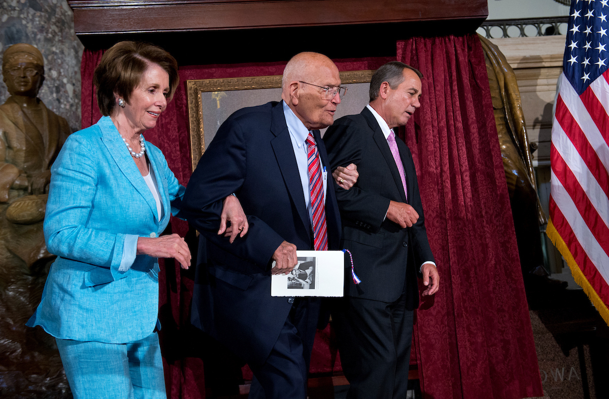 UNITED STATES - JUNE 13: Speaker John Boehner, R-Ohio, right, and House Minority Leader Nancy Pelosi, D-Calif., assist Rep. John Dingell, D-Mich., to his seat in the Capitol's Statuary Hall during a ceremony to honor Dingell as the longest serving member of Congress. He came to Congress in 1955, filling his father's seat. (Photo By Tom Williams/CQ Roll Call)